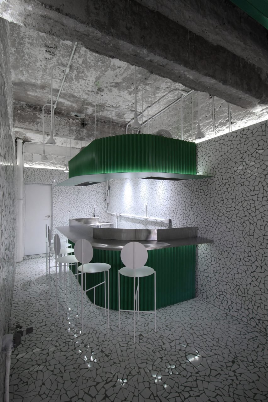 Curved bar with steel stools surrounding it