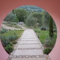 Circular opening through a pink building