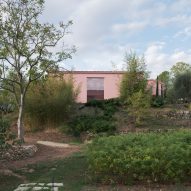 Pink building on a French hillside by Nem Architectes