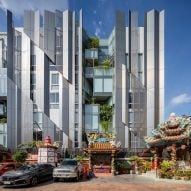 Angled metal screens protect Bangkok office building from direct sunlight