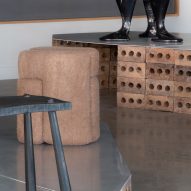 Two black stools of different forms